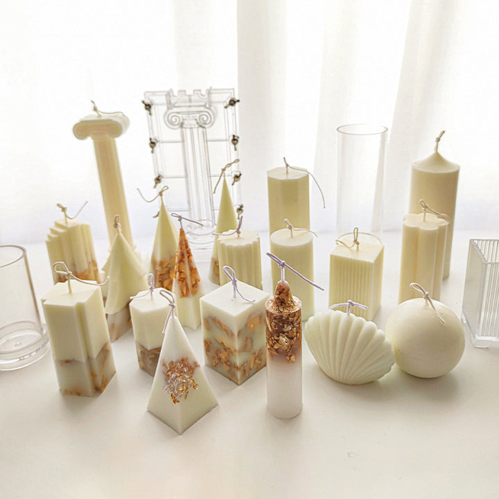Various white and gold decorative candles made using Acrylic Candle Mold from Arts And More craft materials