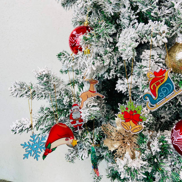 Colorful Christmas Decor Pendants hanging on a snow-covered Christmas tree for festive decoration