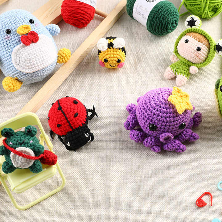 Colorful DIY Doll Tool Kit with crochet animals including a frog, bee, and ladybug for creative projects