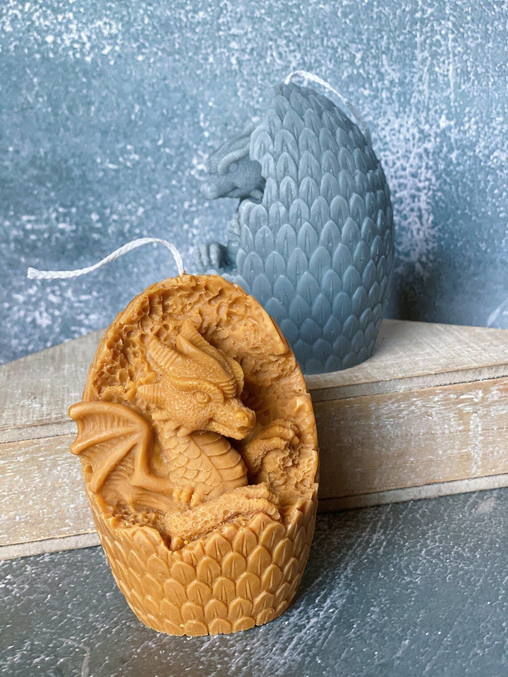 Dragon Egg Candle in a golden hue featuring intricate dragon detailing and textured scales for home decor