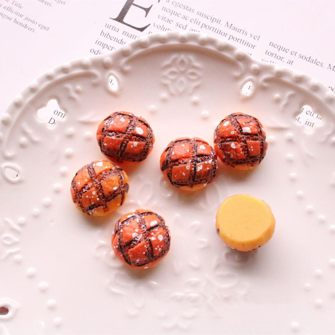 Jewelry Accessories Kit with small brown and yellow decorative beads on a white plate for crafting