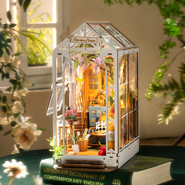 Rolife Garden House Book Nook Kit featuring a miniature greenhouse with vibrant flowers and detailed furnishings