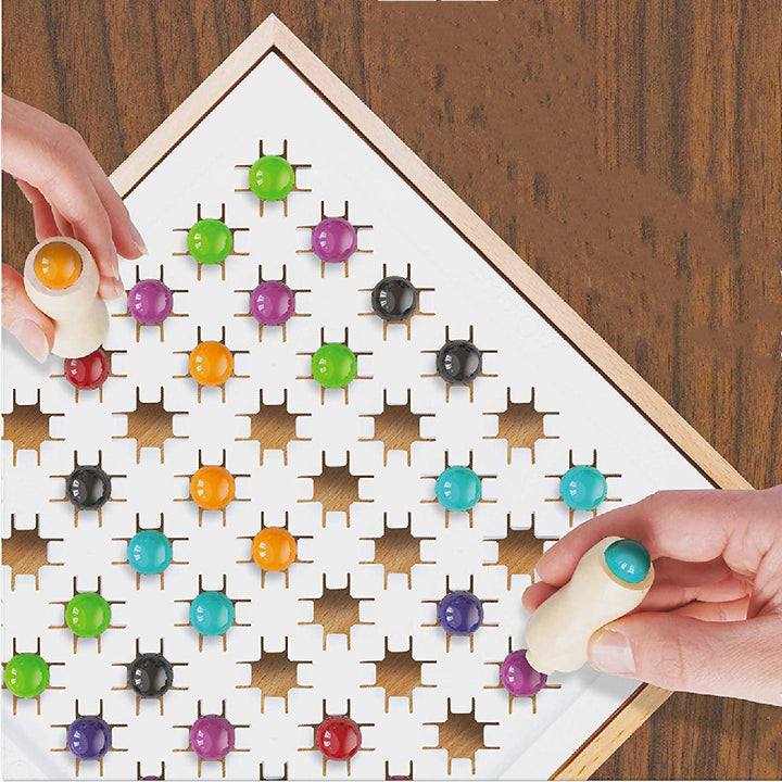 Arts And More Marble Stomping Game with colorful pegs on a wooden board and hands playing