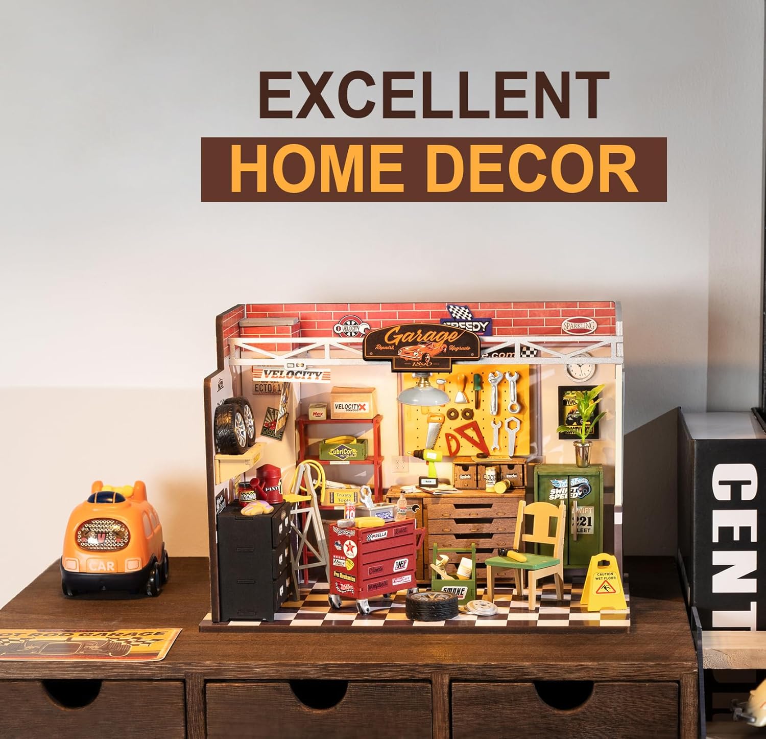 Model garage set up with various items on a wooden surface, labeled 'Excellent Home Decor'.