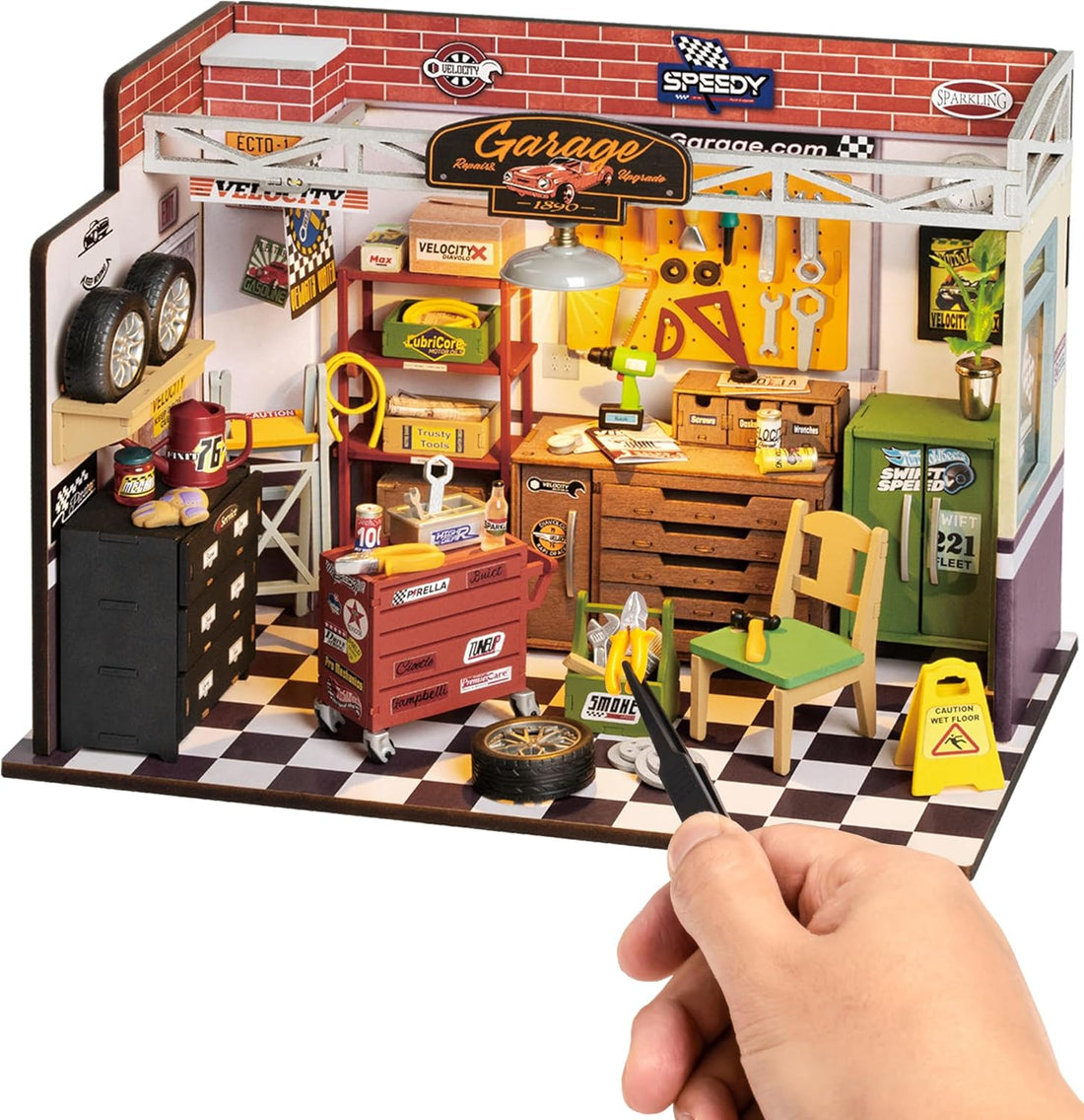 Toy garage set with various accessories and a hand holding a remote control.