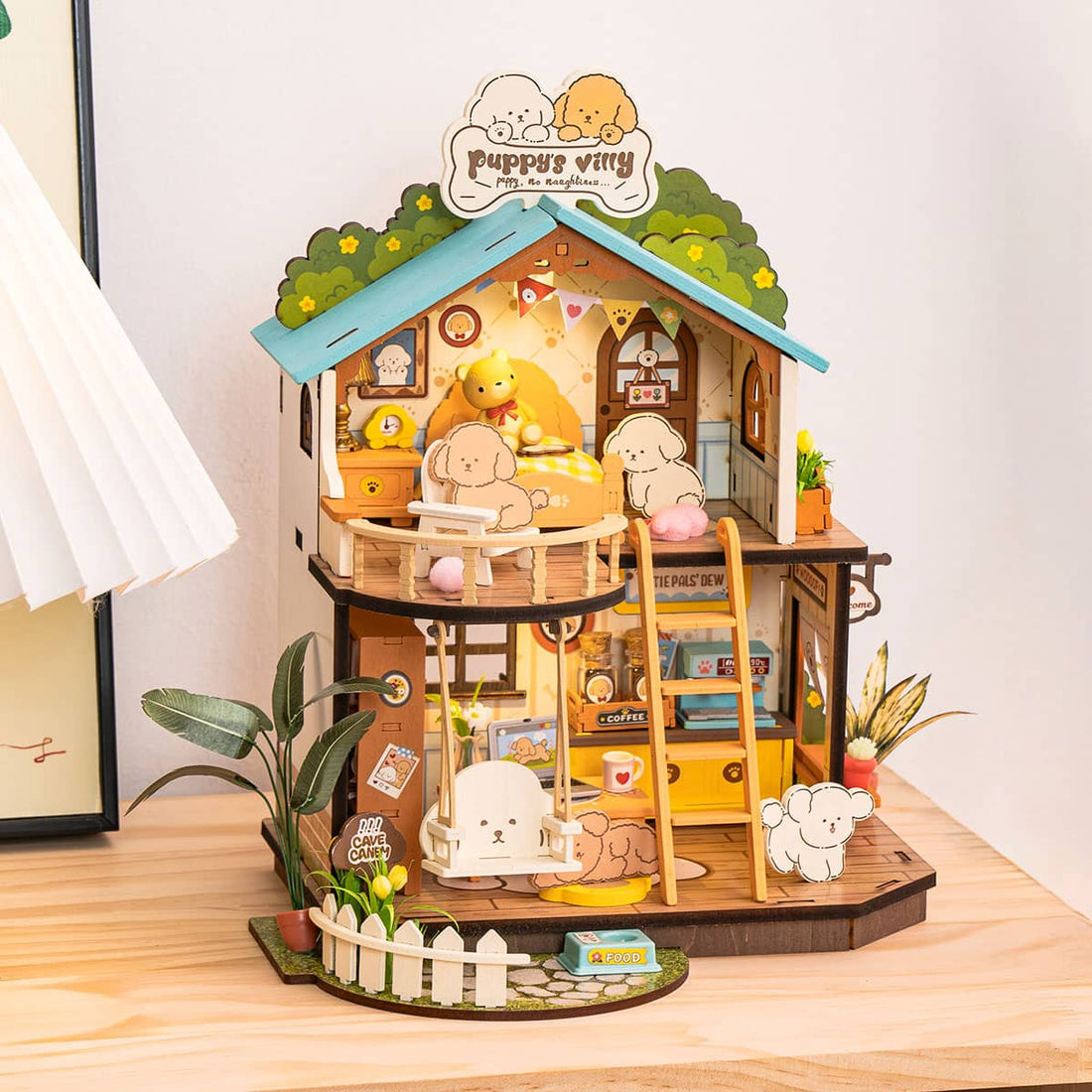 Wooden dollhouse with miniature furniture and animals on a wooden surface.