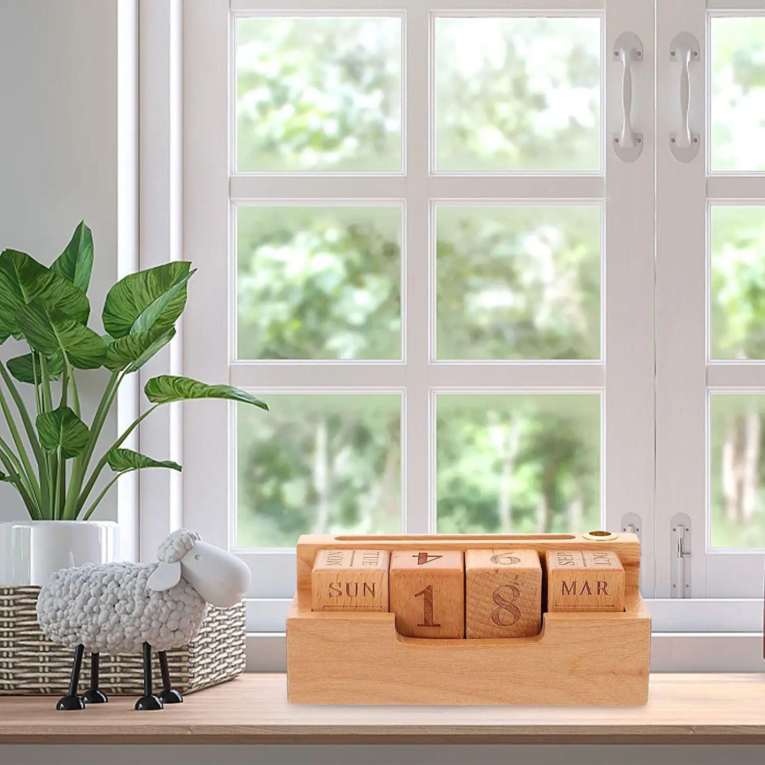 A solid wood creative simple calendar desk with numbers from 1 to 31 carved on each block, placed on a windowsill in a home setting, beside a potted plant and a sheep figurine.