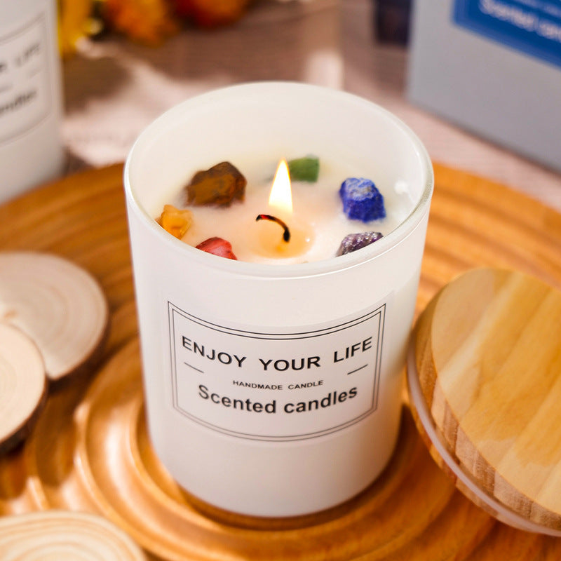 Aromatherapy Candle in a white container with colorful gemstones, placed on a wooden tray