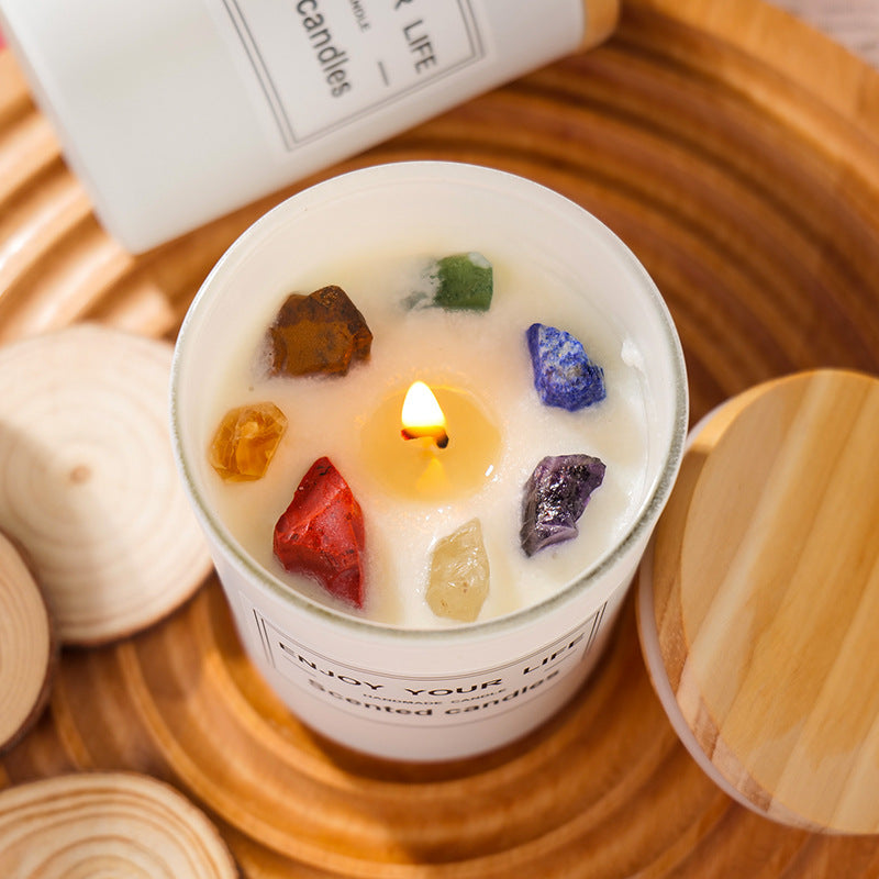 Aromatherapy Candle with Colorful Crystals on Top, Surrounded by Wooden Elements for a Relaxing Atmosphere