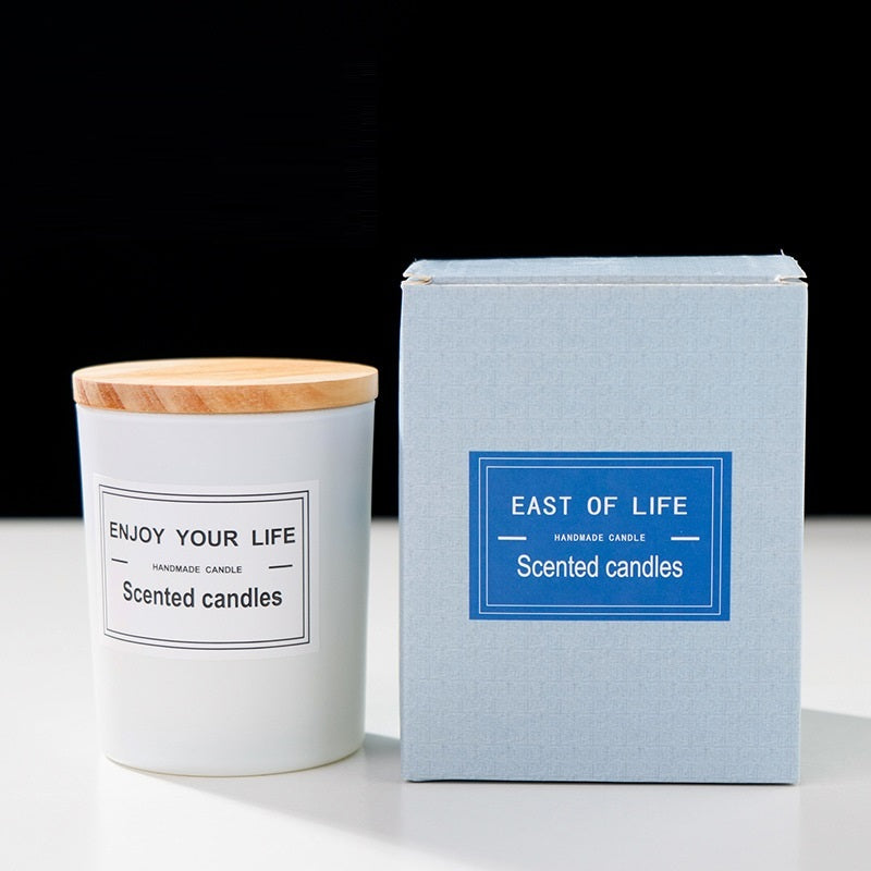 Aromatherapy Candle in a white container with a wooden lid and blue box packaging for relaxation