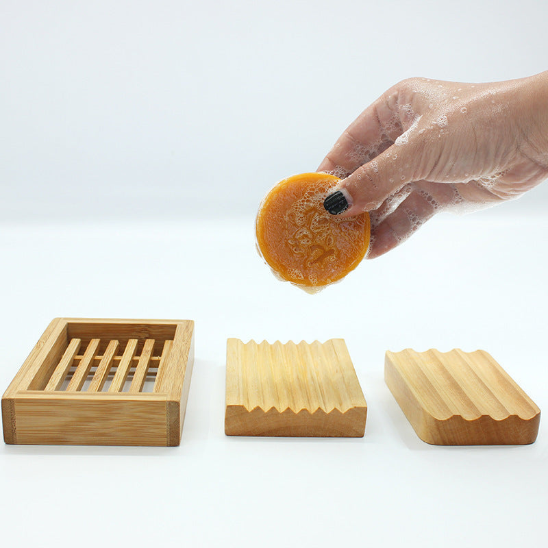 Bamboo Handmade Soap Holder set with grooves and slats displayed with wet handmade soap held by hand