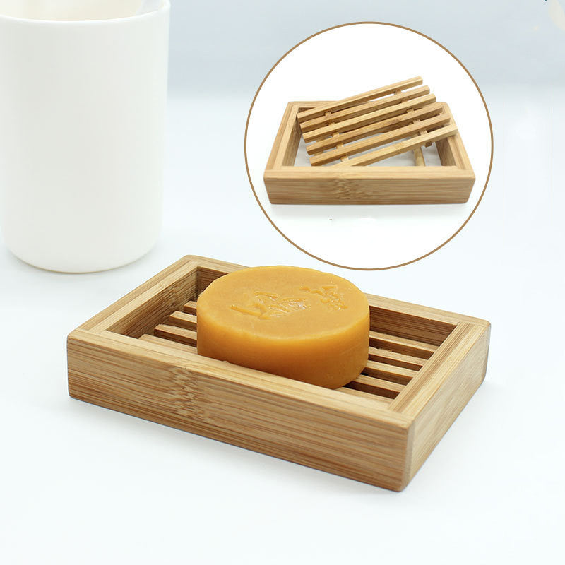Bamboo Handmade Soap Holder with slatted design by Arts And More holding round handmade soap
