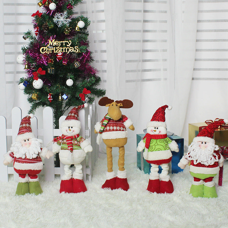 Cute Christmas decorations featuring plush characters near a decorated tree in a festive setting