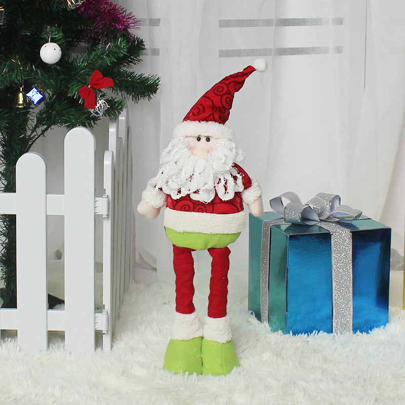 Festive Santa doll Christmas decorations with fluffy beard and colorful outfit near a tree
