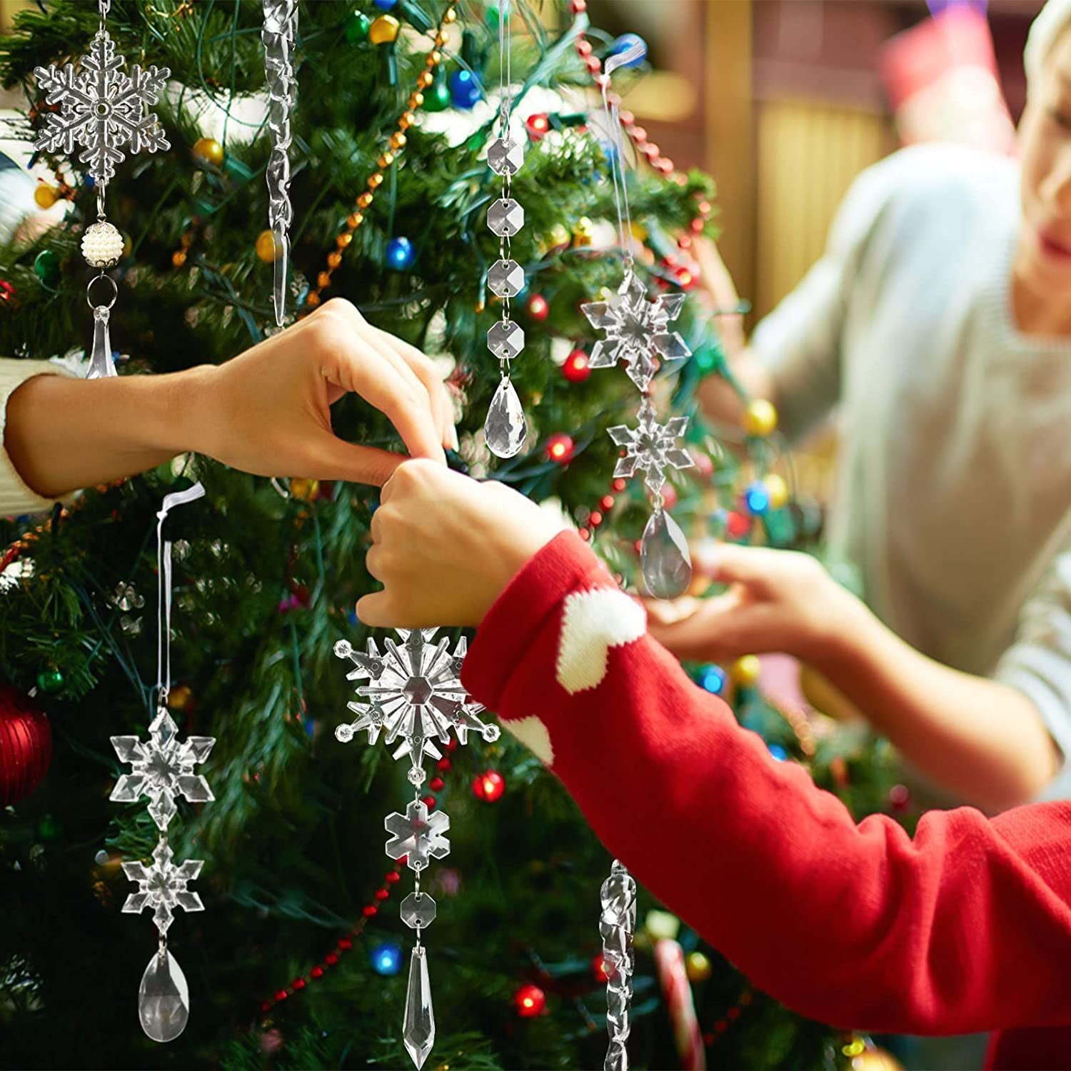 Family hanging Christmas Tree Hanging Pendants on a beautifully decorated Christmas tree
