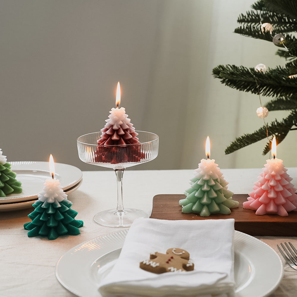 Set of Christmas Tree Scented Candle decorations on a table, featuring festive green and pink colors