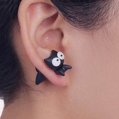 Close-up of black bat clay animal earrings worn on ear by Arts And More