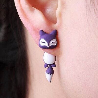 Purple and white Clay Animal Earrings shaped like a cute fox worn on a person's ear by Arts And More