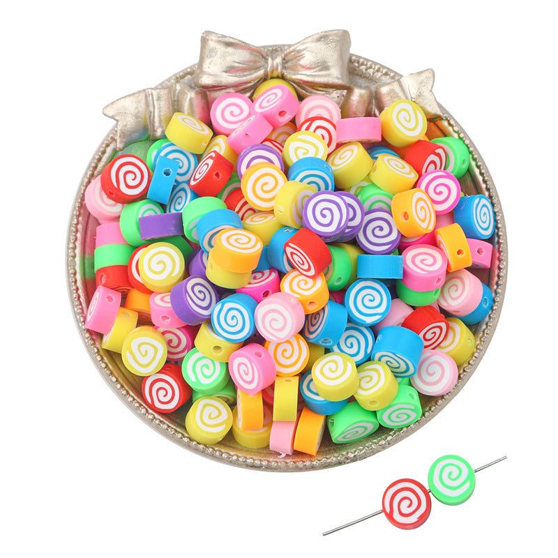 Colorful spiral patterned clay beads in a decorative silver bowl by Arts And More