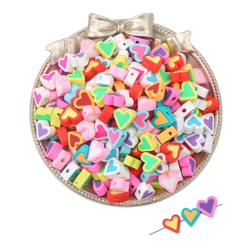 Colorful heart-shaped clay beads in various colors arranged in a decorative bowl by Arts And More