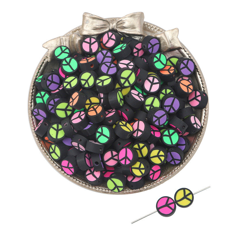 Colorful peace sign clay beads in black base displayed in decorative bowl for craft materials