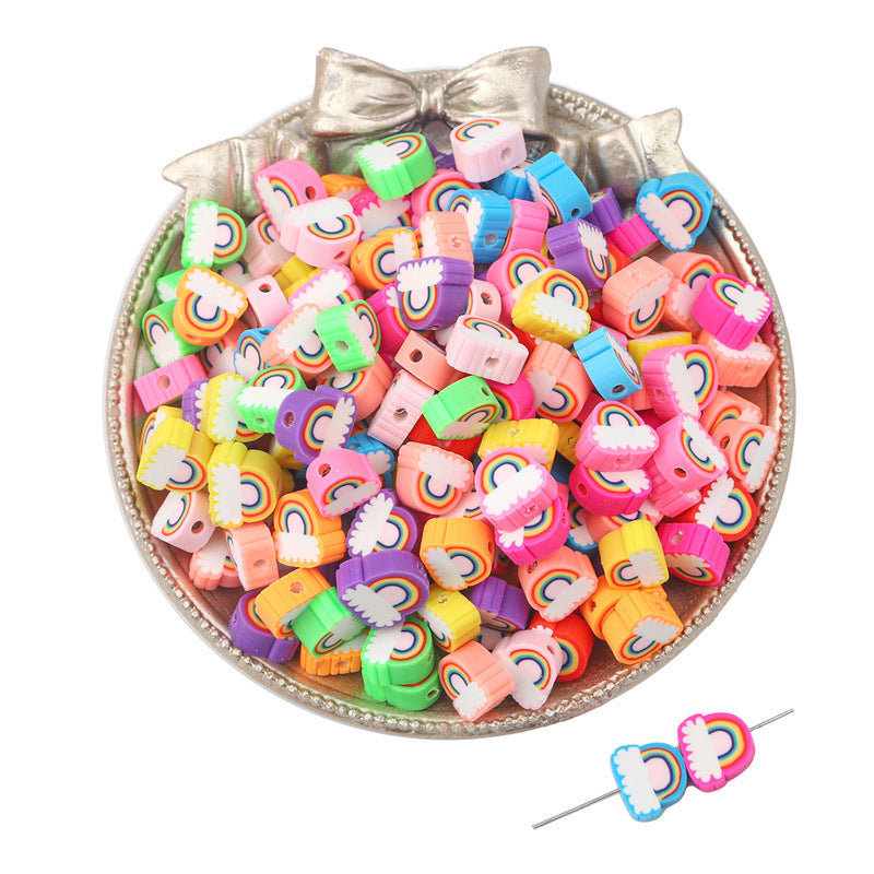 Colorful rainbow patterned clay beads in various bright colors in a decorative silver bowl