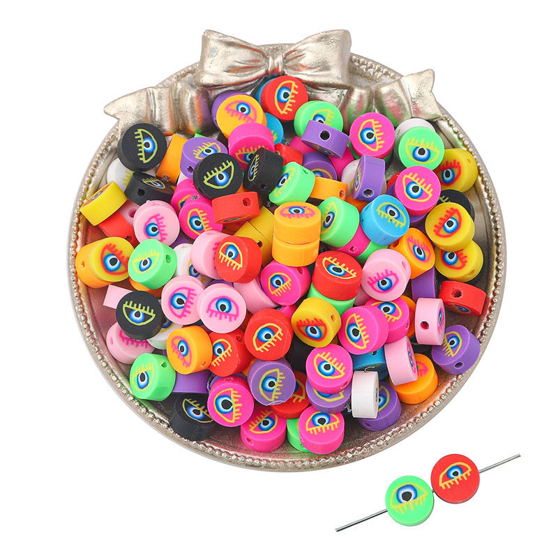 Colorful Arts And More clay beads with eye designs in a decorative silver bowl for craft projects