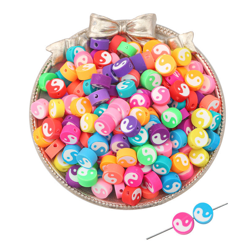 Colorful yin yang clay beads in various bright colors on a decorative silver tray for crafting