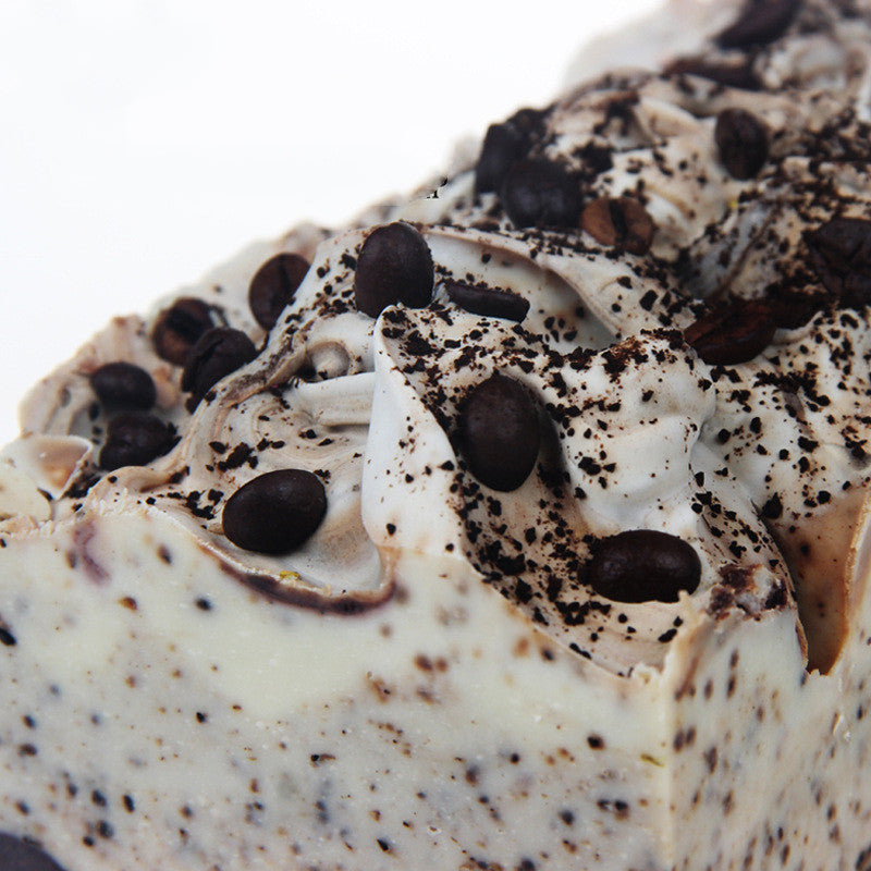 Close-up of Arts And More Coffee Essential Oil Soap with coffee beans and textured creamy surface