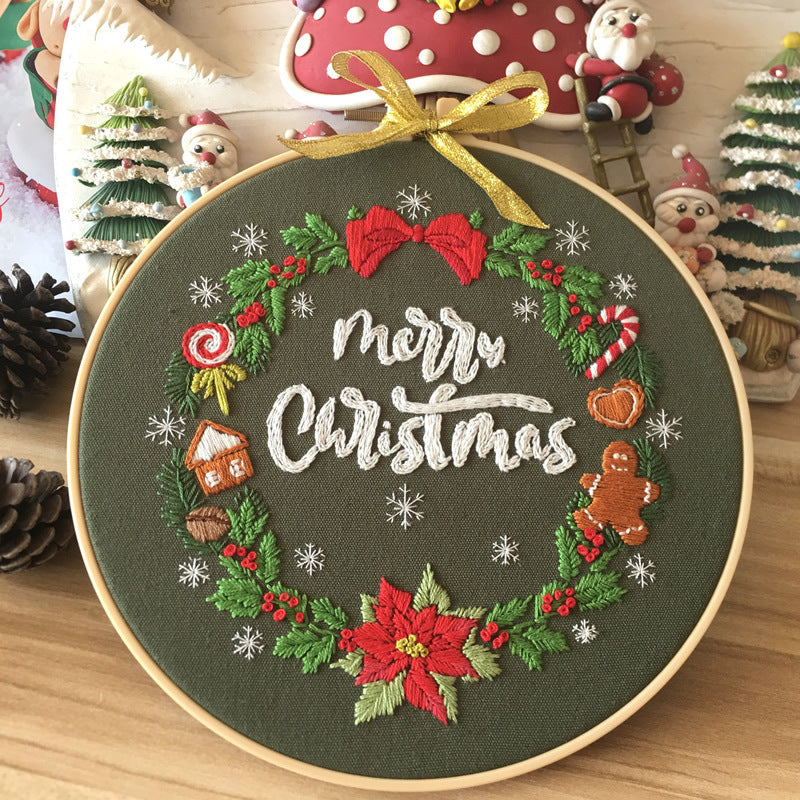 Arts And More Christmas-themed Cross Stitch Kit featuring a festive wreath design with Merry Christmas text