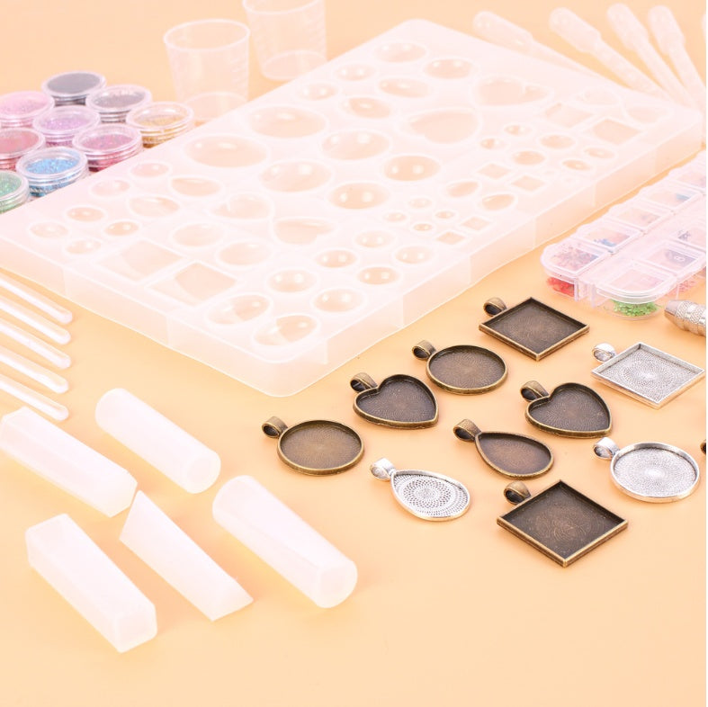 Arts And More Crystal Glue Mold Set with resin molds, pendant frames, glitter pots, and mixing tools for craft projects