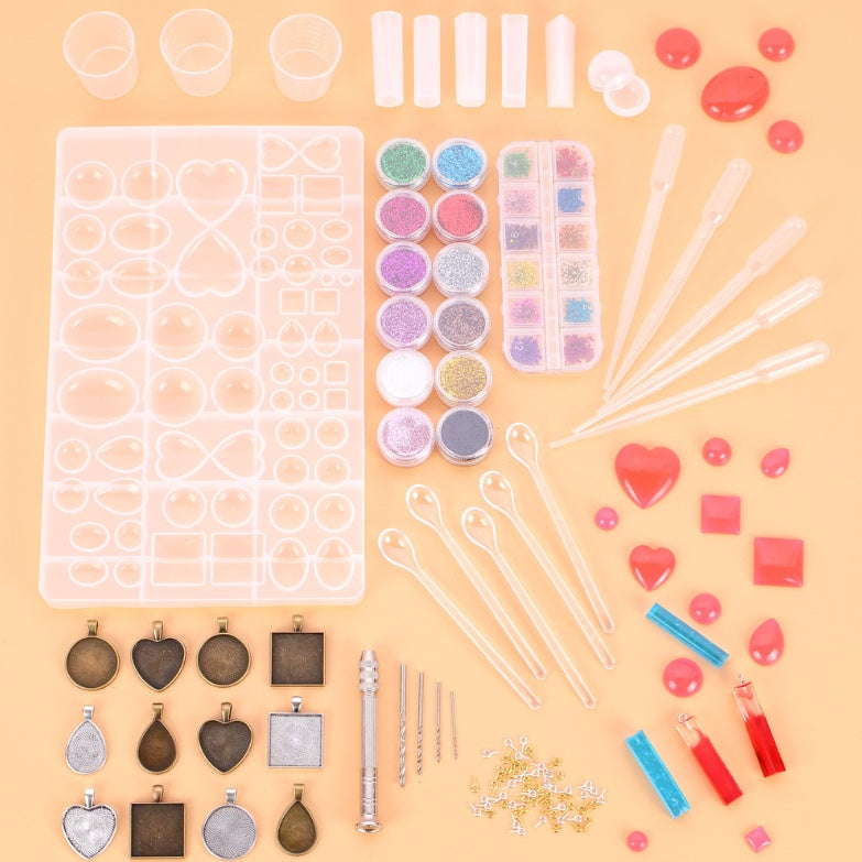 Arts And More Crystal Glue Mold Set with various molds, glitter powders, and crafting tools for resin art