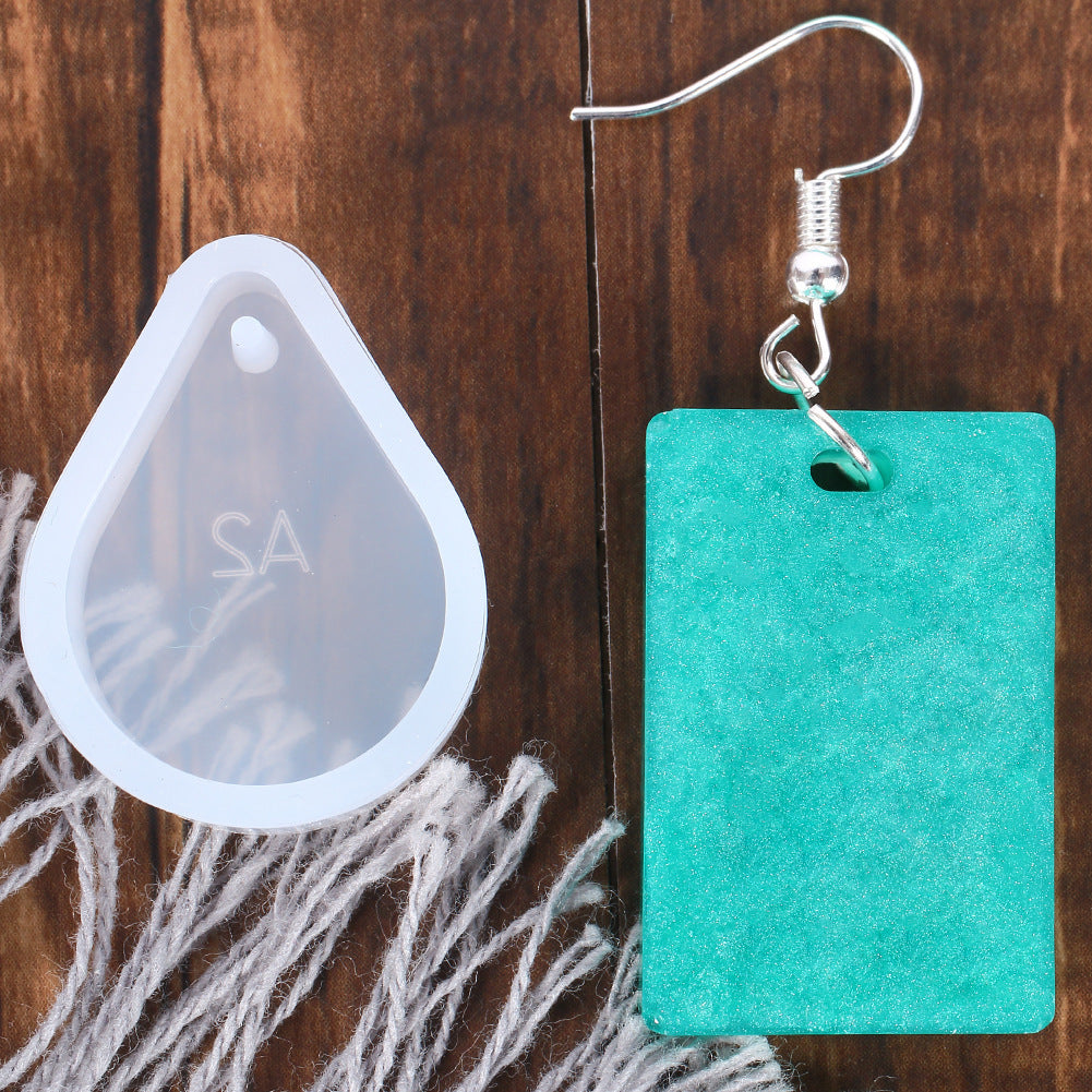 Crystal Glue Tool Jewelry Making Set featuring a drop-shaped mold and a green earring pendant