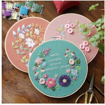 Three DIY Embroidery Practice Kits featuring colorful floral designs in wooden hoops