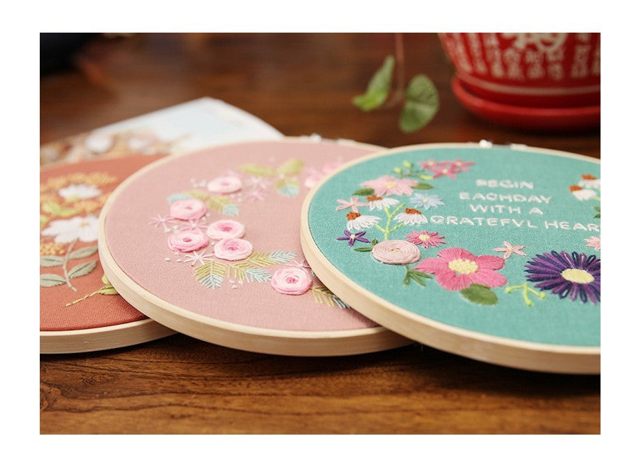 DIY Embroidery Practice Kits featuring colorful floral designs on wooden hoops for crafting enthusiasts