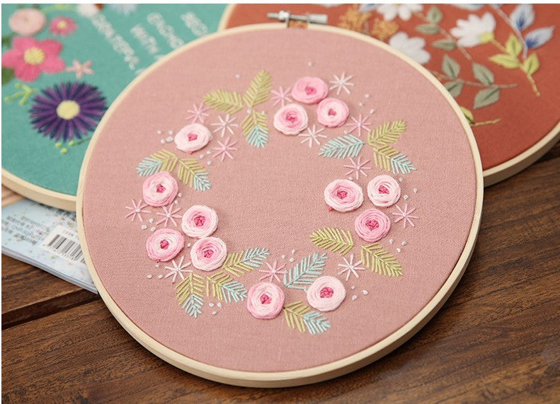 Beautiful DIY Embroidery Practice Kits featuring floral designs on a pink background