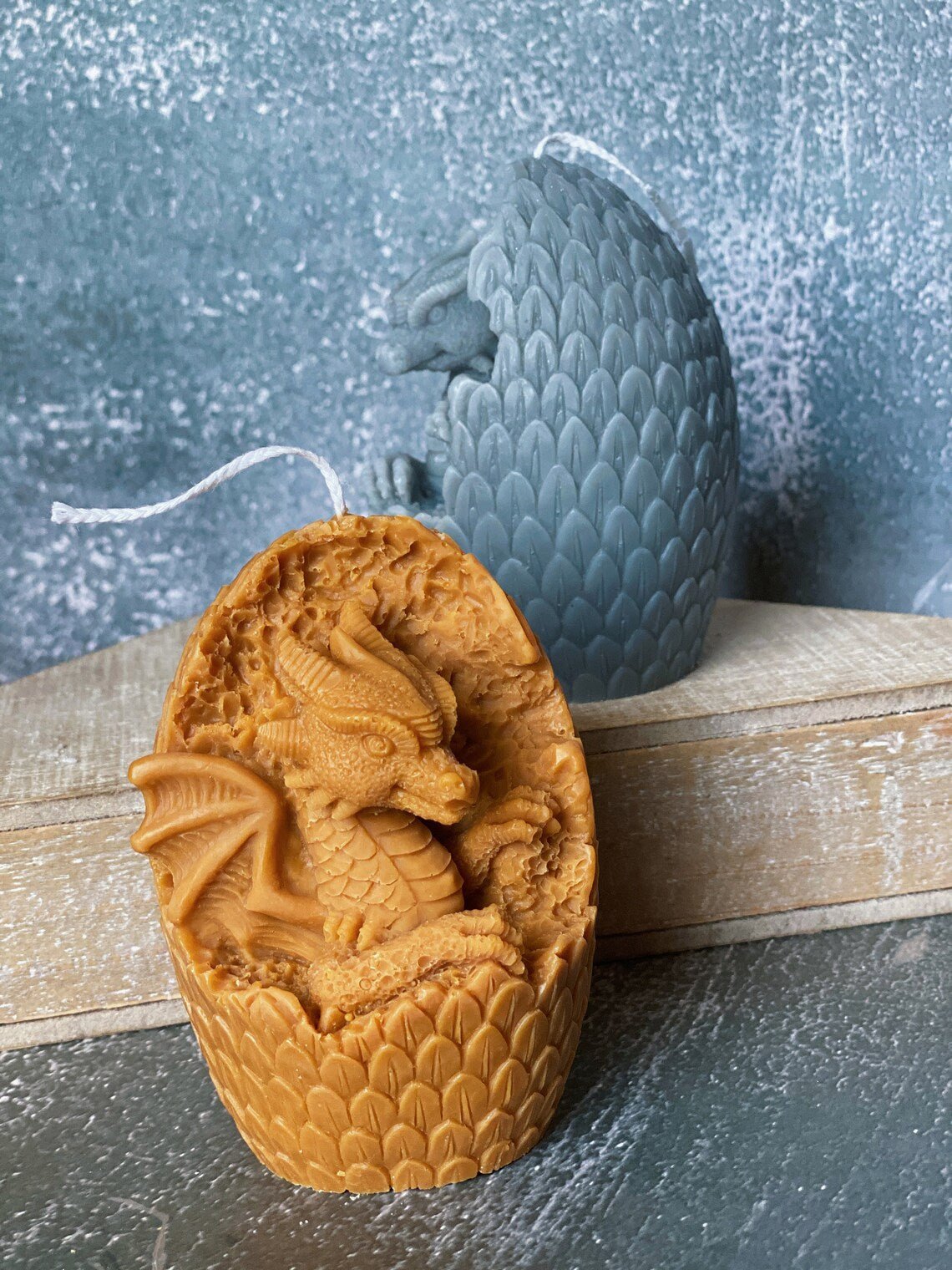 Dragon Egg Candle in orange and blue with intricate dragon design, perfect for whimsical home decor