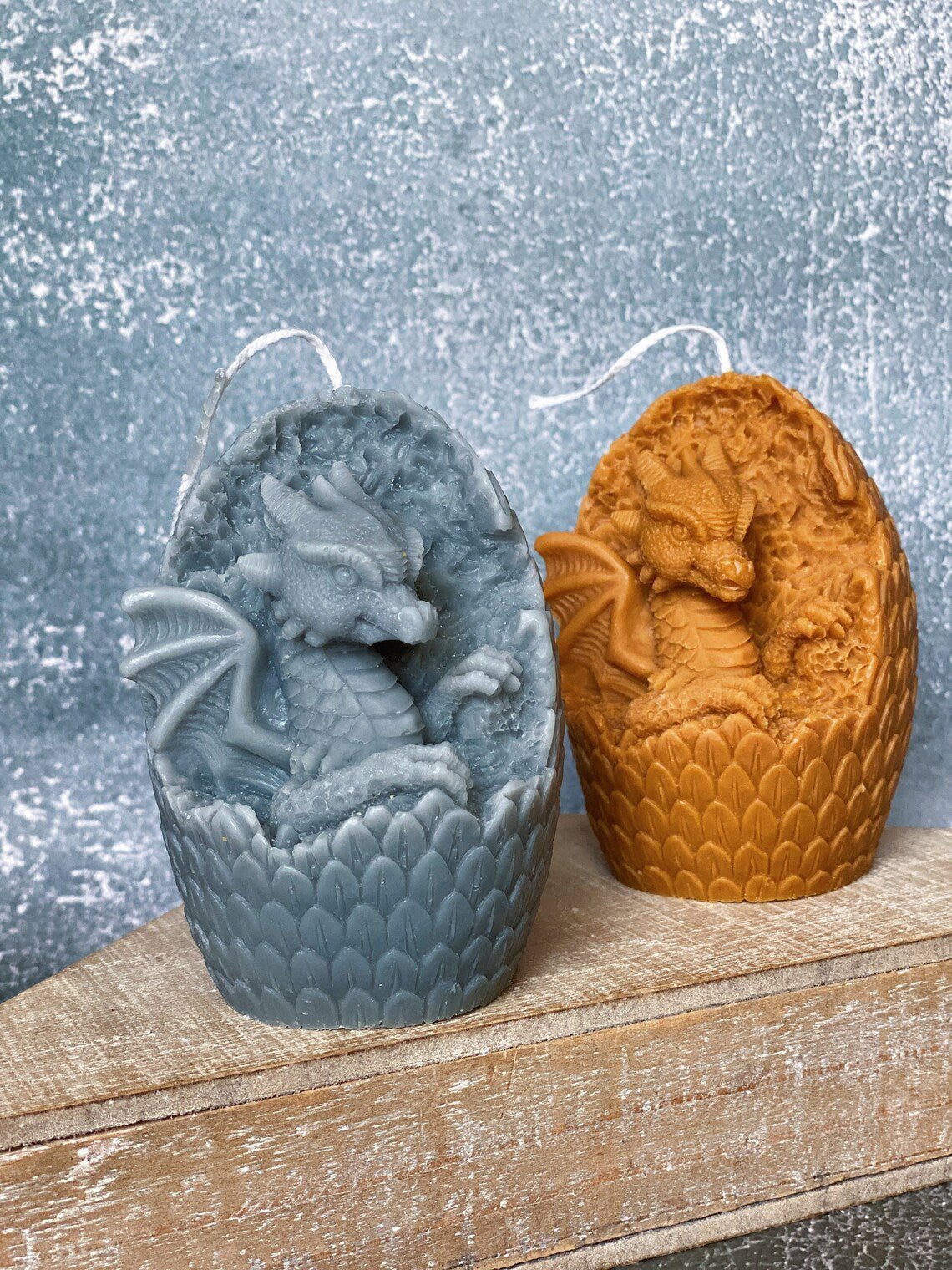 Set of two Dragon Egg Candles in grey and orange, featuring intricate dragon designs for unique decor