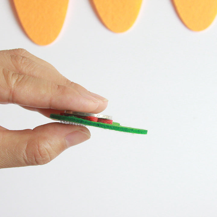 Hand holding a green felt piece from Arts And More Kids’ DIY Kits Educational Matching Toy