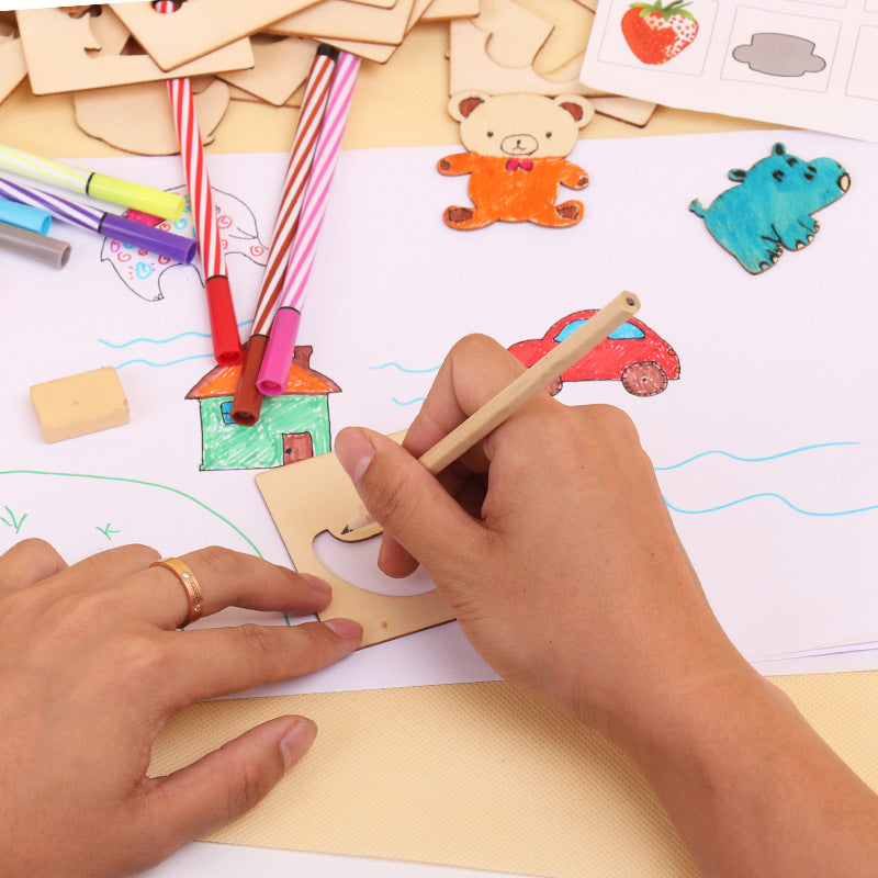 Child using wooden painting kit to color wooden shapes of animals and objects with markers on paper