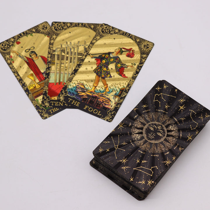 Gold Foil Tarot cards with detailed illustrations and a celestial-themed reading cloth