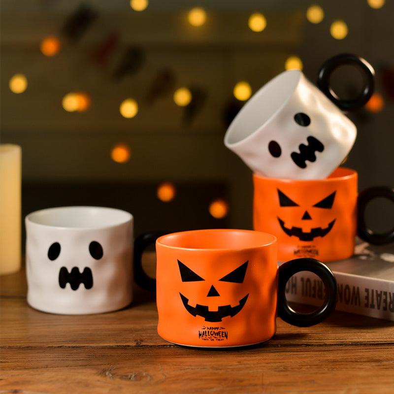 Set of three Halloween-themed Pumpkin Cups in orange and white with spooky face designs