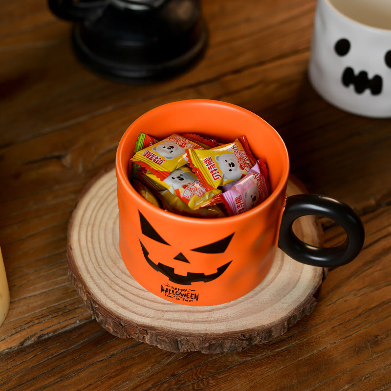 Orange Pumpkin Cup with a spooky design, filled with assorted candy for Halloween treats