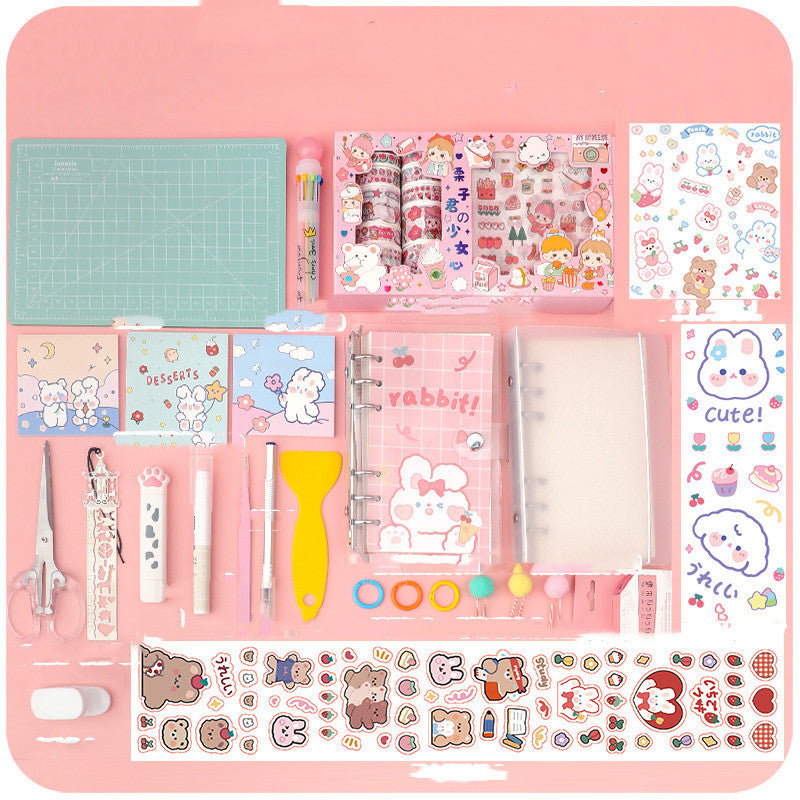 Arts And More Hand Account arts and crafts kit with stickers scissors pens and decorative supplies on pink background