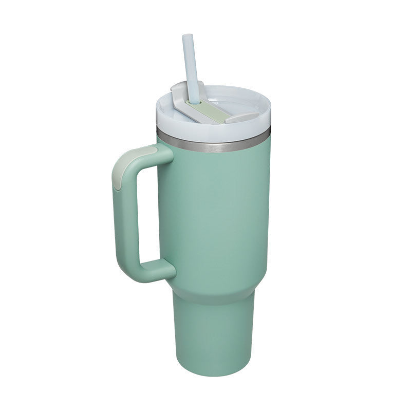 Arts And More insulated tumbler with handle in light green with white lid and straw for hot and cold drinks