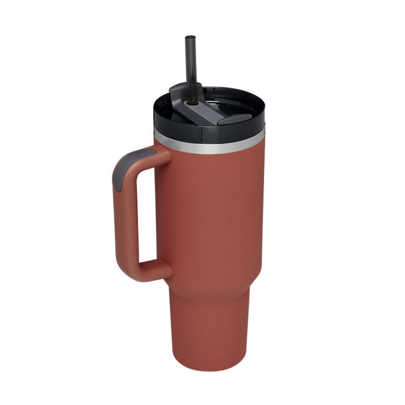 Arts And More insulated tumbler with handle in rust color featuring a black lid and straw for easy drinking