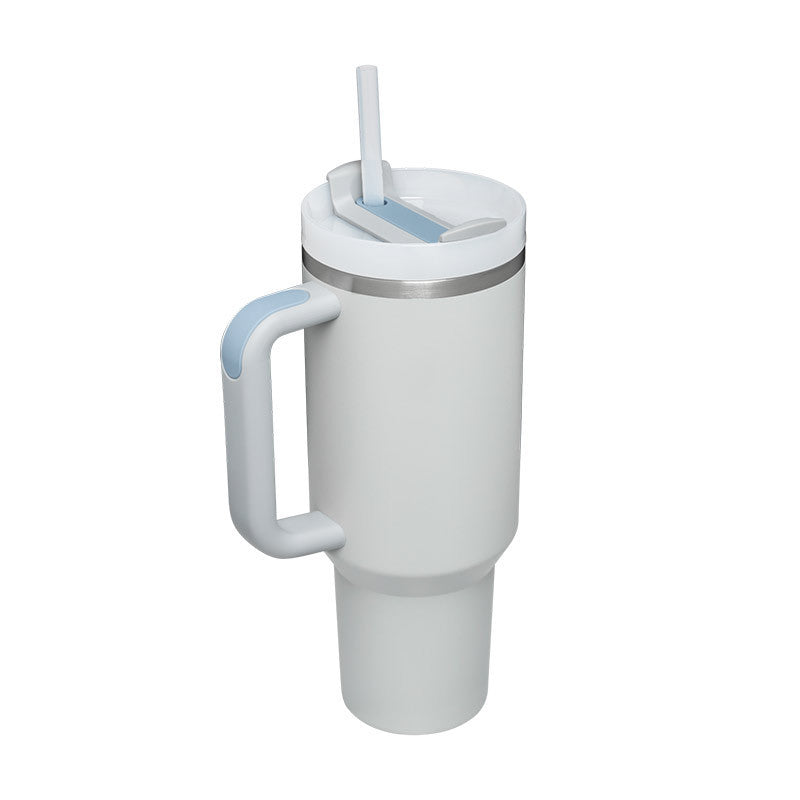 White insulated tumbler with handle and straw designed for keeping drinks hot or cold
