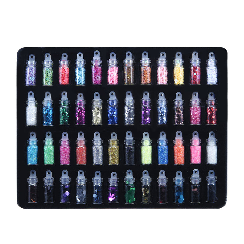 Assorted craft materials in tiny bottles for jewelry pendant making geometric mold projects