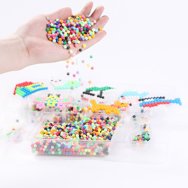 Child's hand pouring colorful beads from the Magic Beads Handmade Toy Set for creative DIY projects