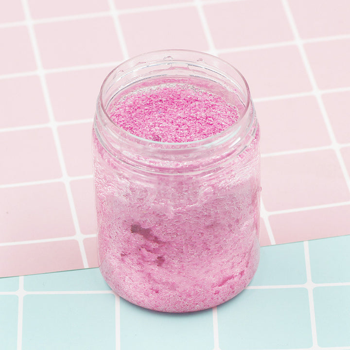 Arts And More Kids DIY Kit with pink Magic Sand in clear jar on pastel grid background